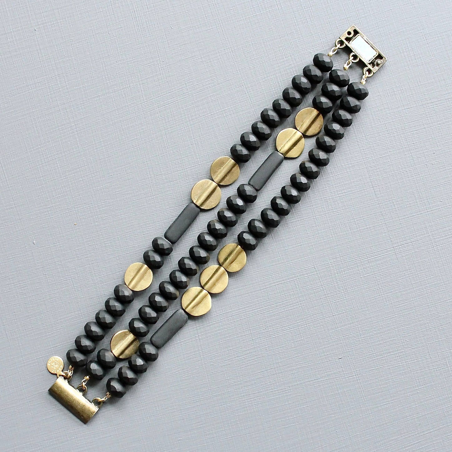 JLTB07 black and brass triple strand bracelet