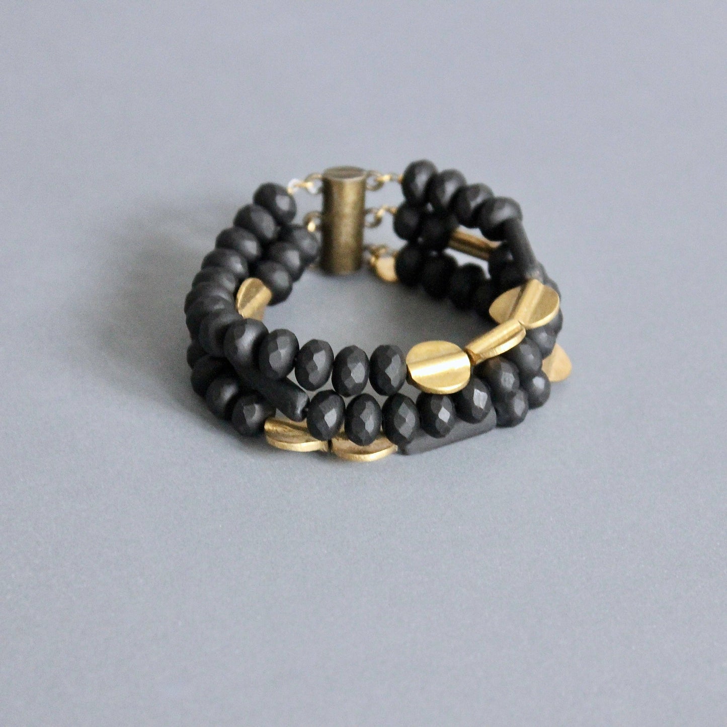 JLTB07 black and brass triple strand bracelet