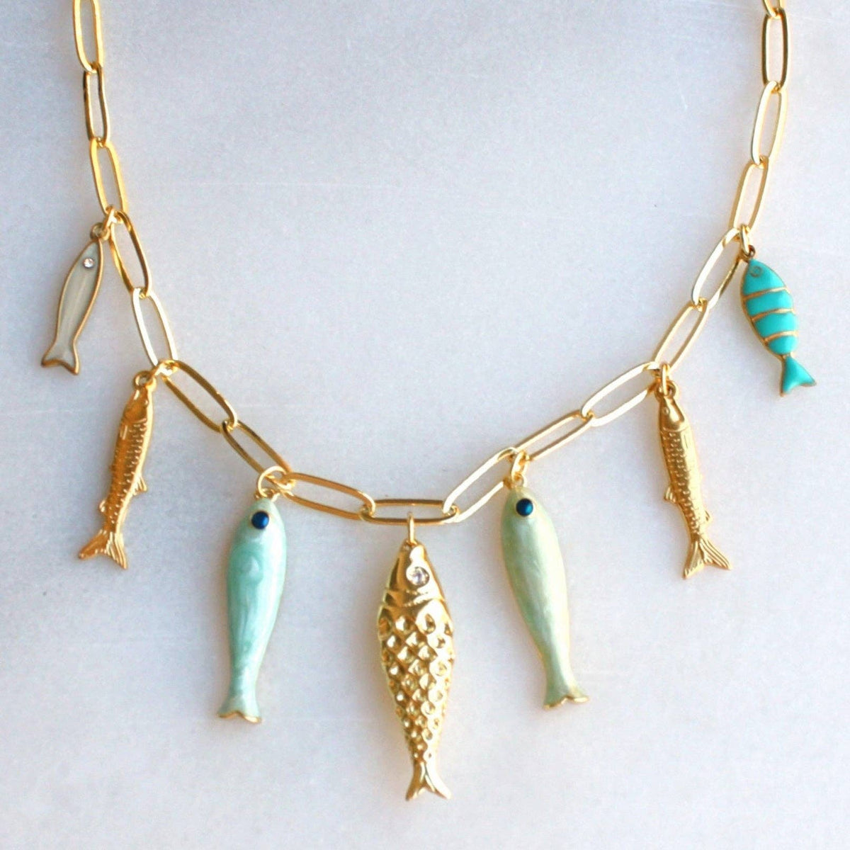 Desert Tide Necklace – Gold Chain with Playful Fish Charms